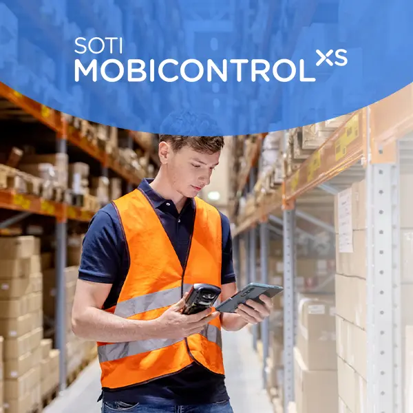 Man staring at devices in a warehouse. SOTI Mobicontrol XS